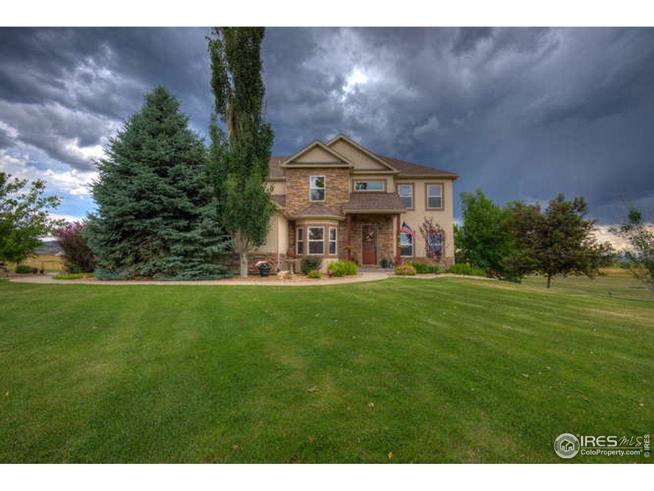 1441 Shelby Drive Berthoud, CO 80513 - Photo 39 of 40 a view of a big house with a big yard and large tree