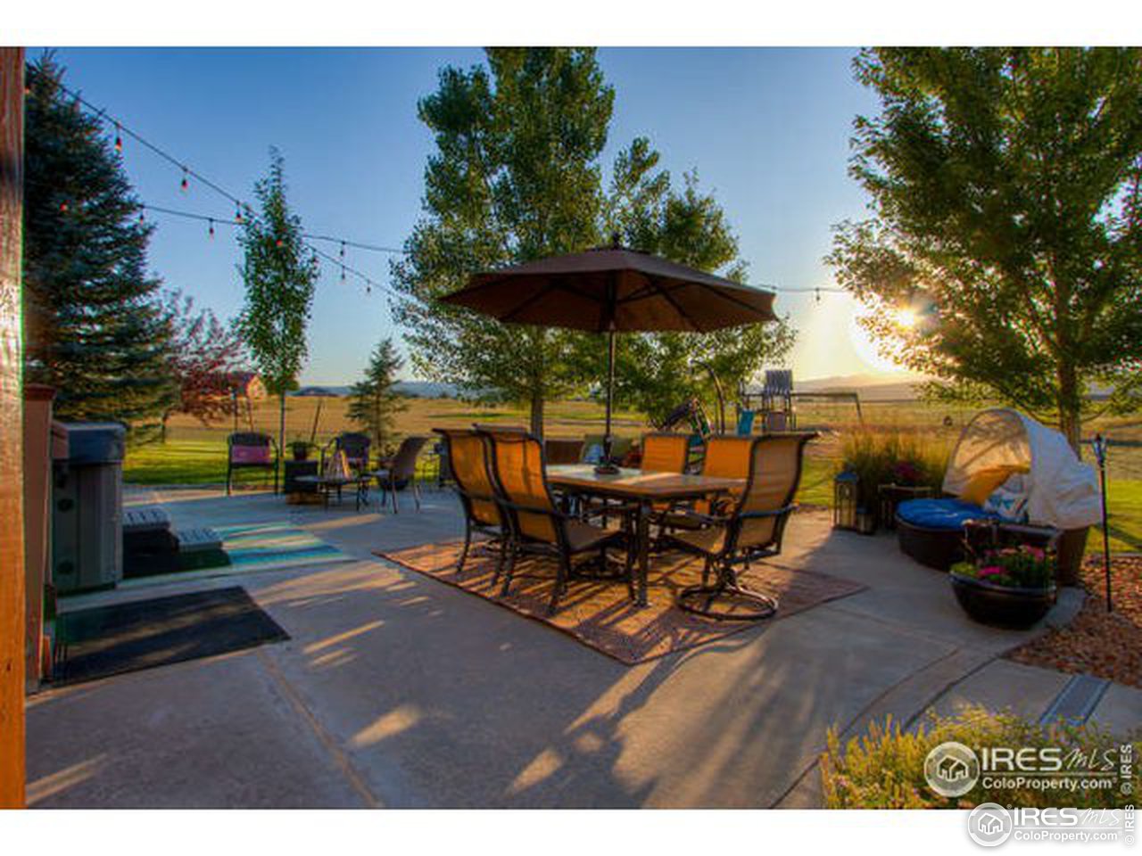 1441 Shelby Drive Berthoud, CO 80513 - Photo 10 of 40 a view of a patio with table and chairs potted plants with wooden fence