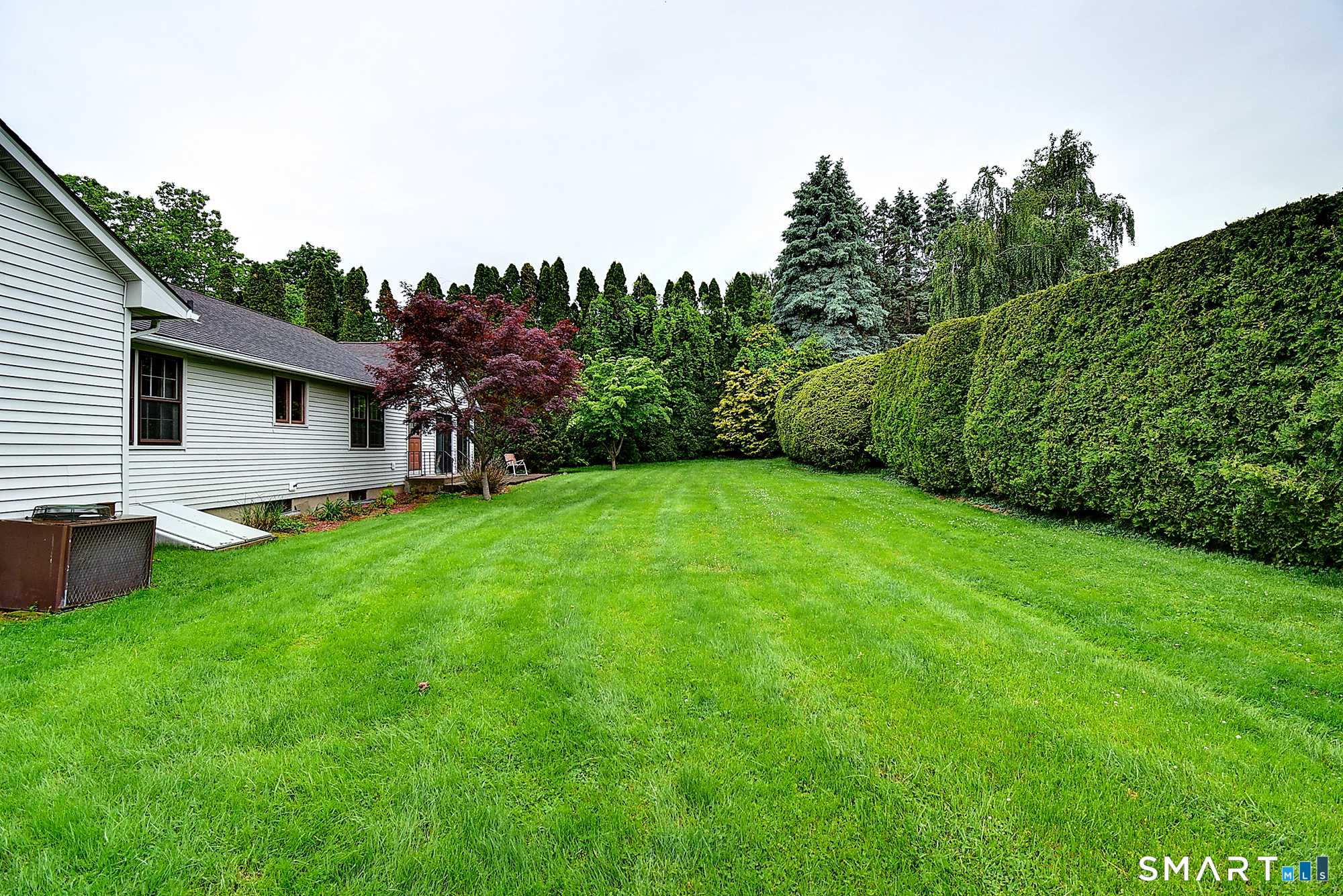 80 Grist Mill Road Wethersfield, CT 06109 - Photo 2 of 40 a view of a backyard with a garden