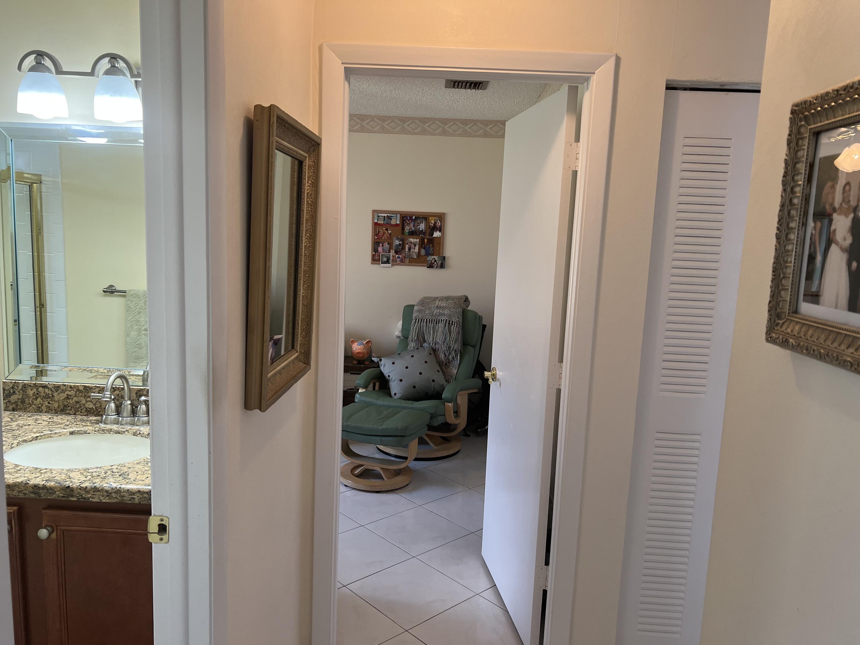6877 Moonlit Drive Delray Beach, FL 33446 - Photo 11 of 45 a bathroom with a granite countertop sink and a mirror