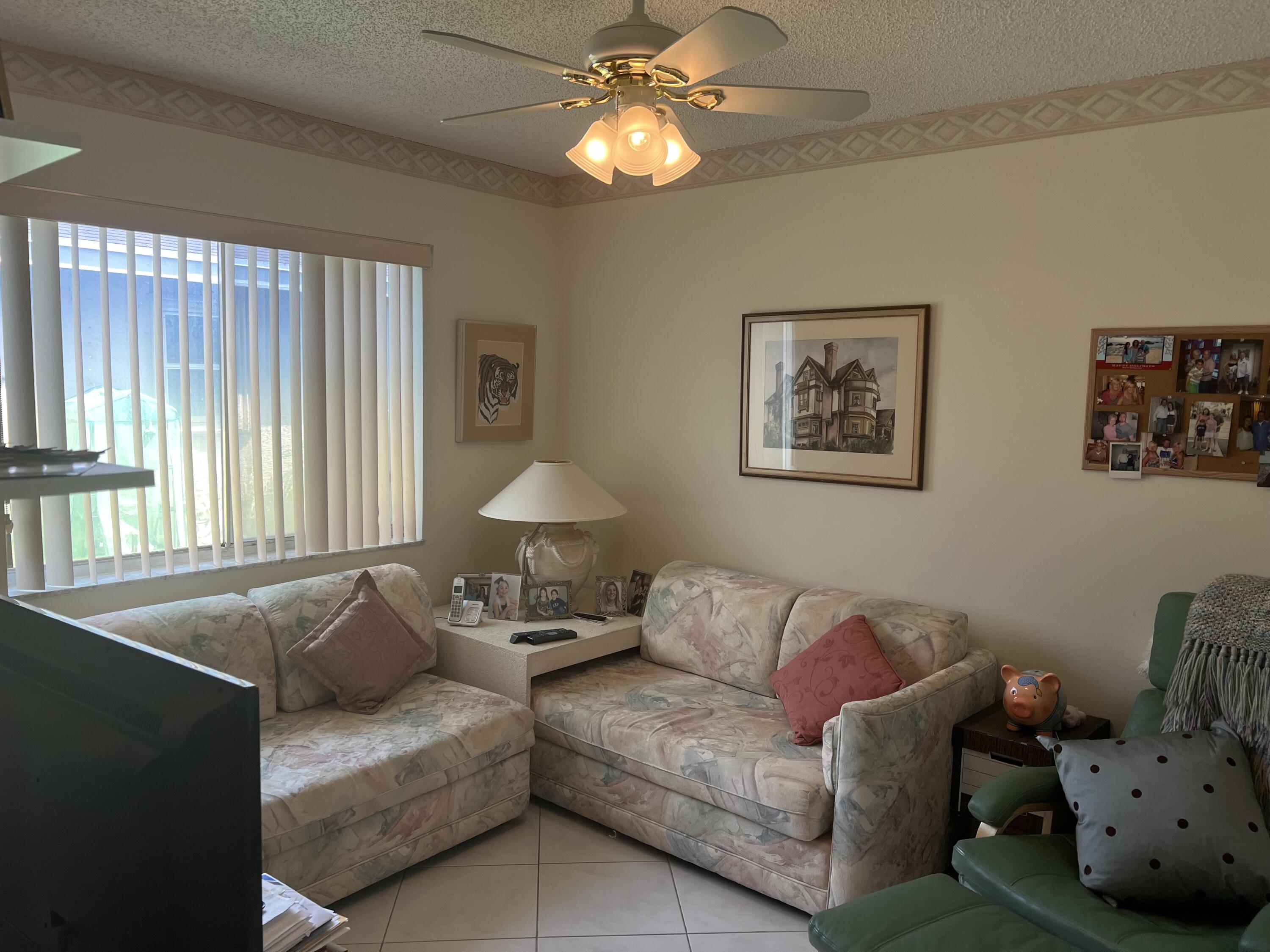 6877 Moonlit Drive Delray Beach, FL 33446 - Photo 12 of 45 a living room with furniture and a chandelier