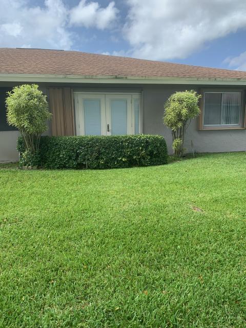 6877 Moonlit Drive Delray Beach, FL 33446 - Photo 17 of 45 a front view of a house with garden