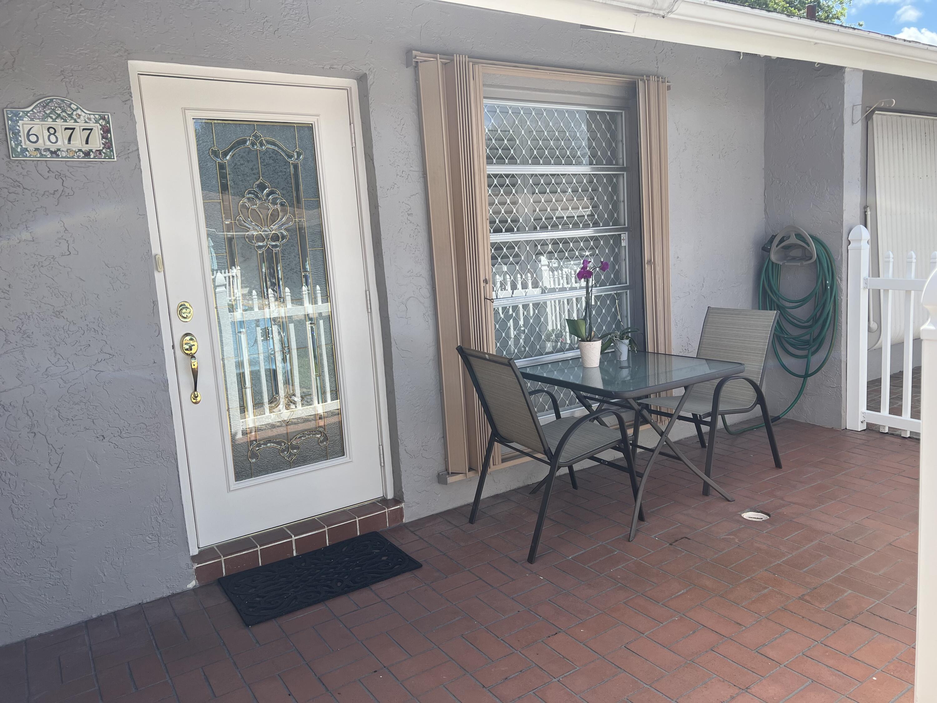 6877 Moonlit Drive Delray Beach, FL 33446 - Photo 20 of 45 a view of a livingroom with furniture and a window