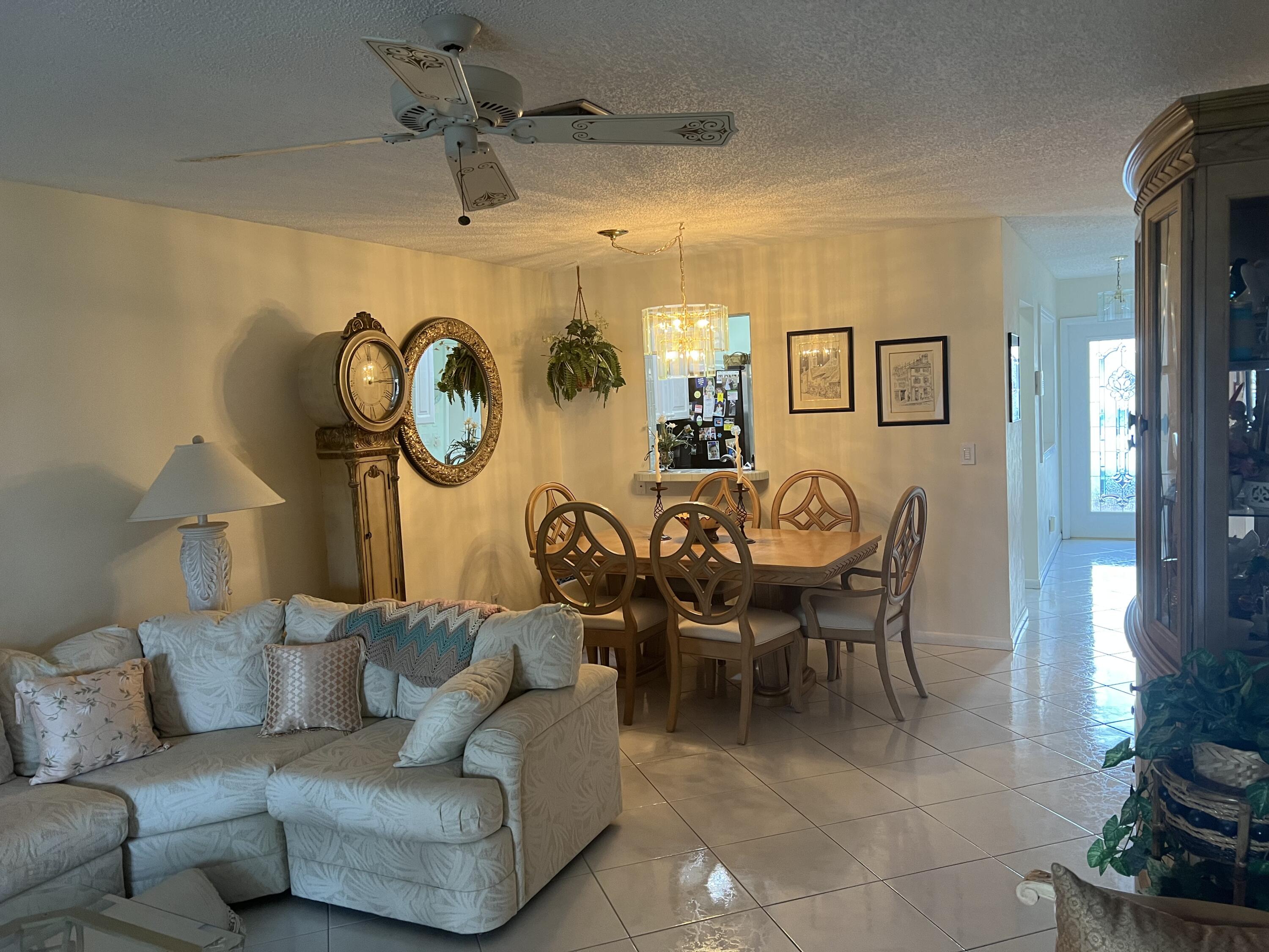 6877 Moonlit Drive Delray Beach, FL 33446 - Photo 31 of 45 a living room with furniture and a clock