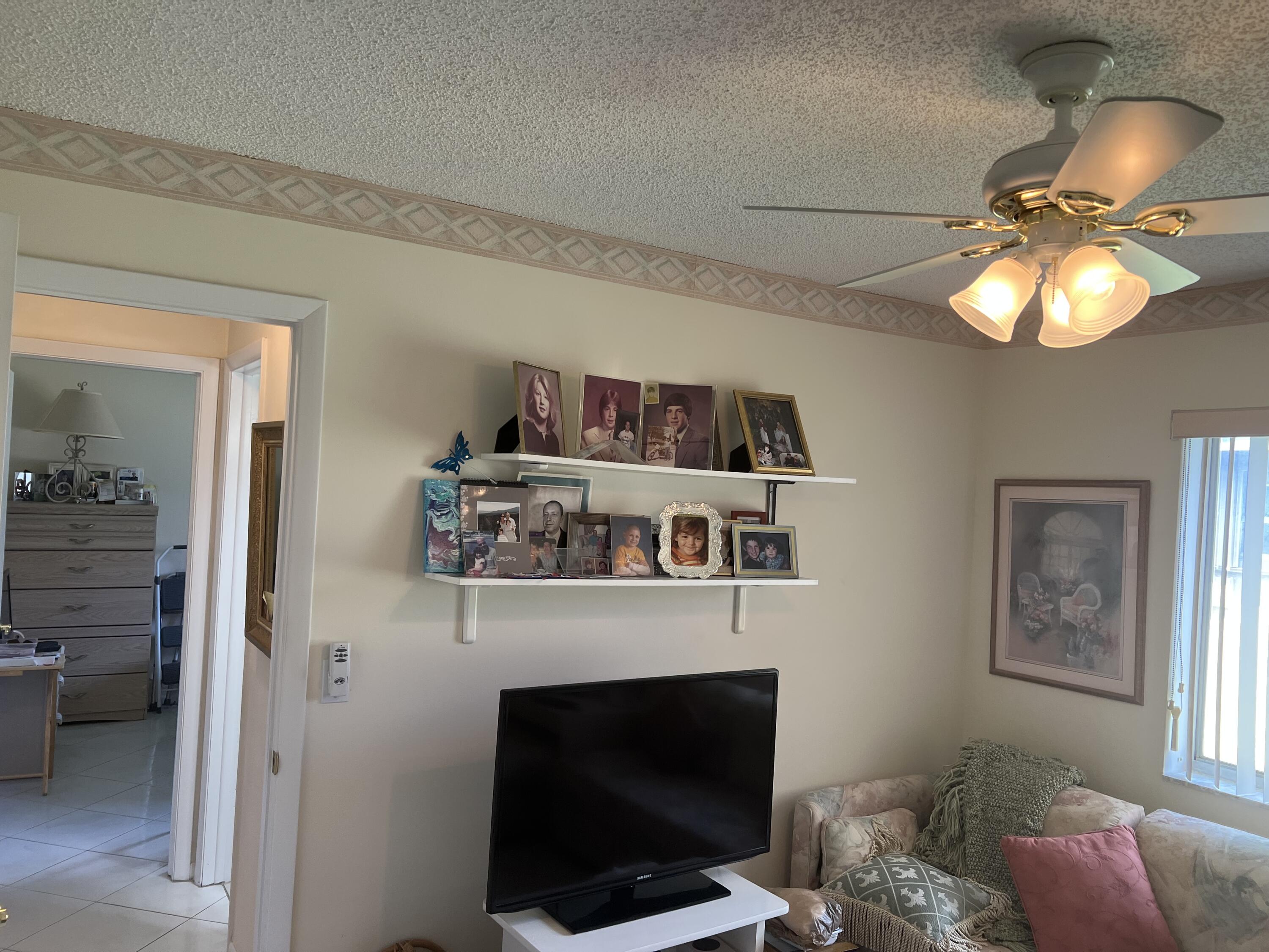 6877 Moonlit Drive Delray Beach, FL 33446 - Photo 33 of 45 a living room with furniture and a fireplace