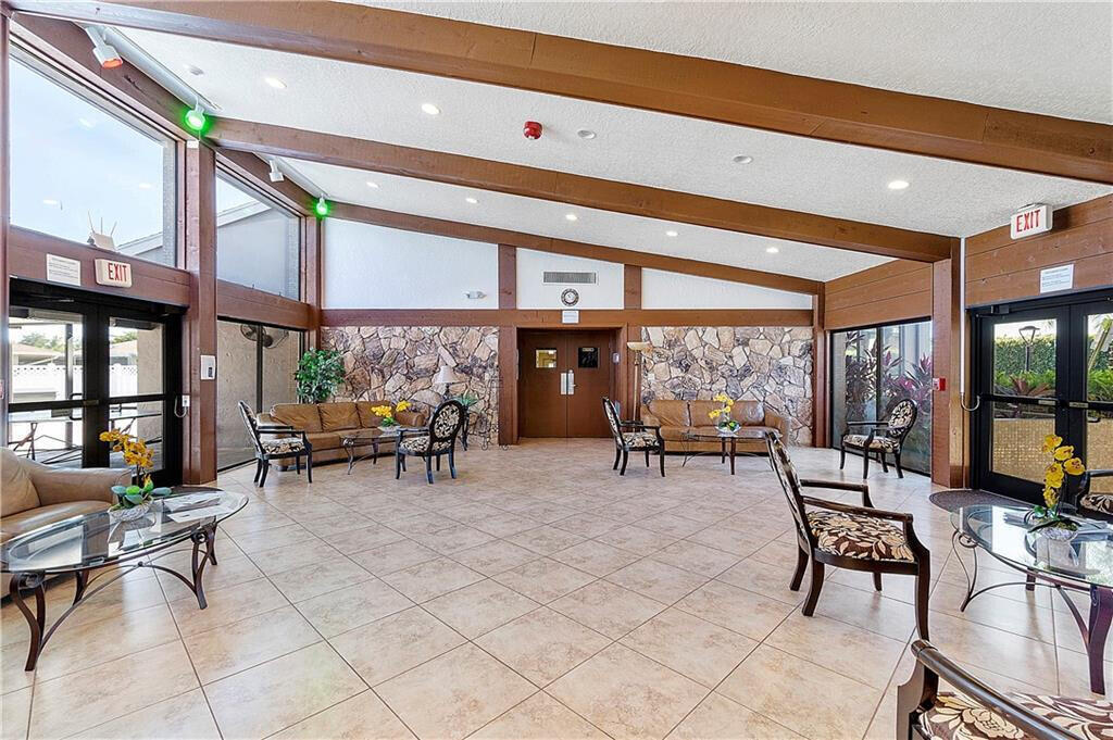 6877 Moonlit Drive Delray Beach, FL 33446 - Photo 38 of 45 a living room with furniture a fireplace and large windows