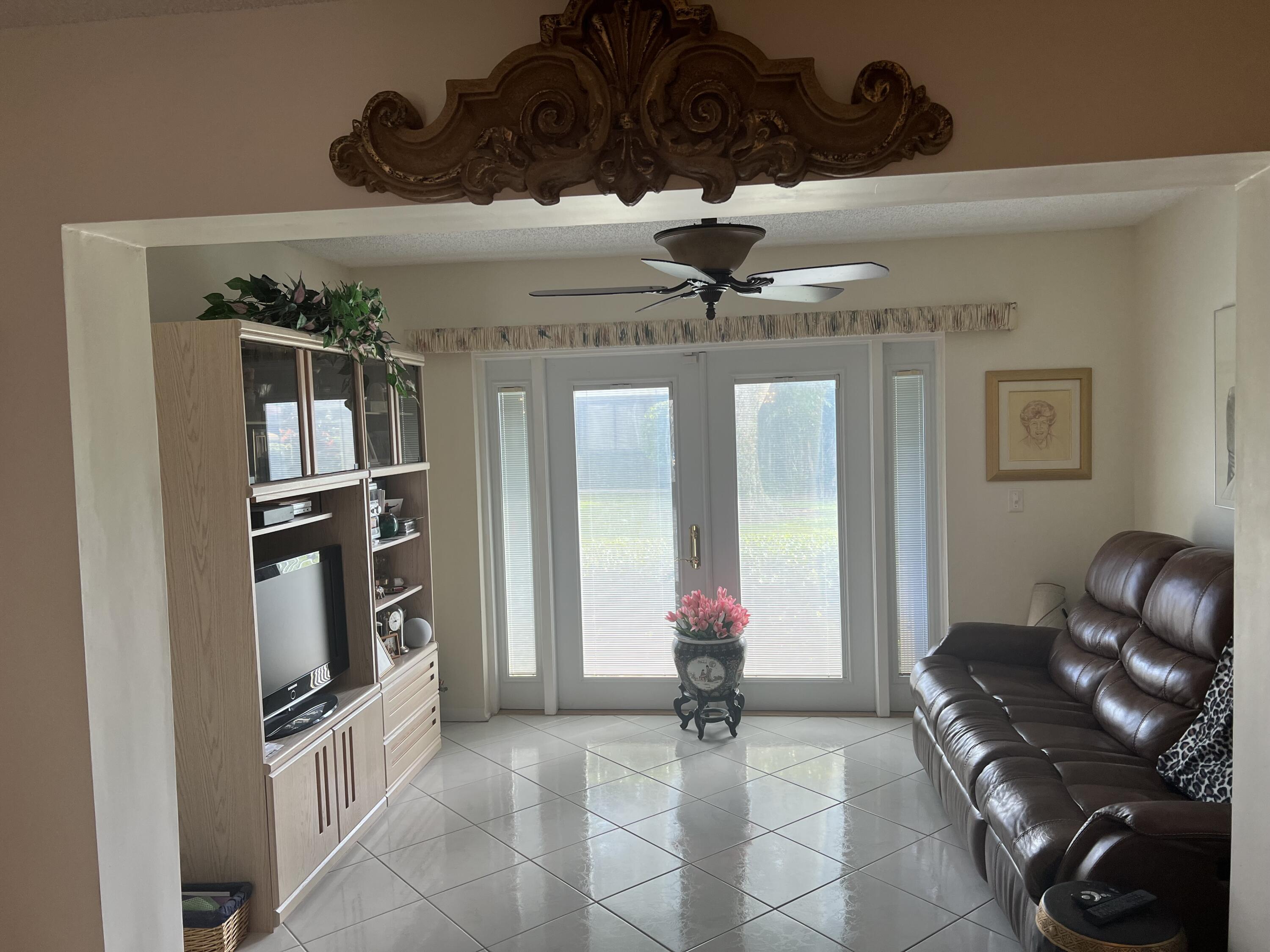 6877 Moonlit Drive Delray Beach, FL 33446 - Photo 7 of 45 a view of a livingroom with furniture and a chandelier