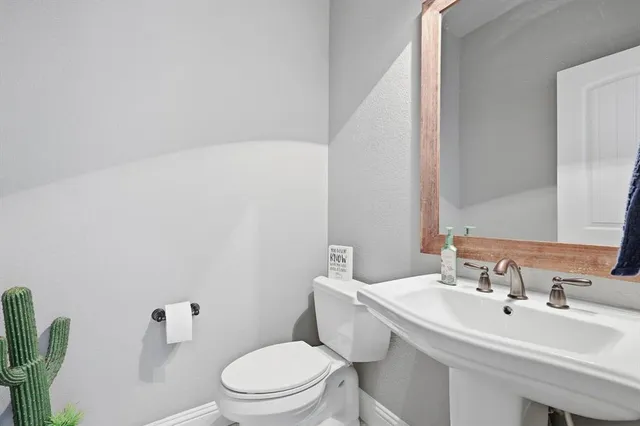 a bed sitting in a spacious bedroom next to a window