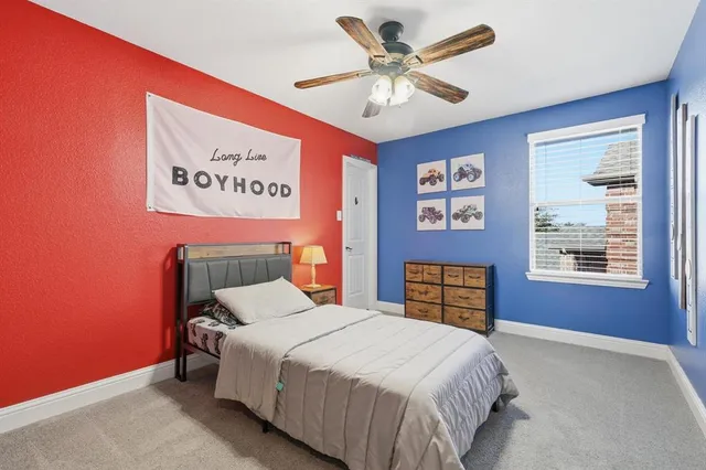 a bedroom with a bed dresser and a window