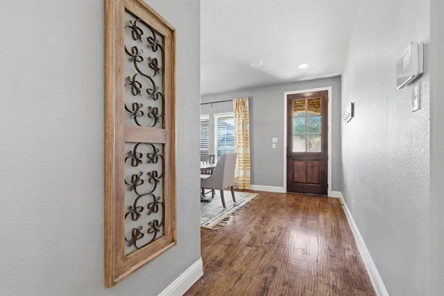 a dining room with wooden floor and a window