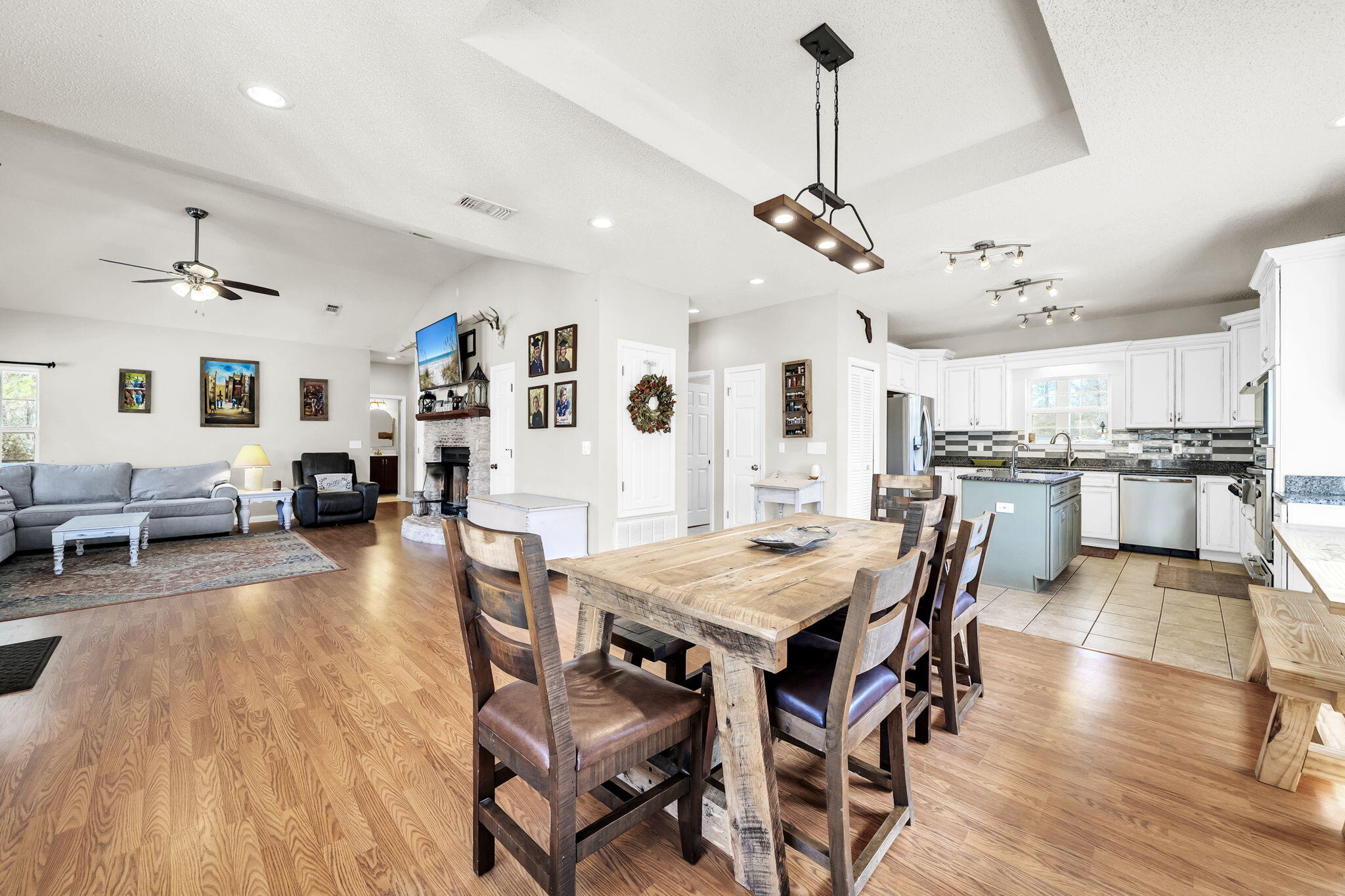 4398 Wilkerson Bluff Road Holt, FL 32564 - Photo 24 of 110 a view of a dining room and livingroom with furniture wooden floor a chandelier
