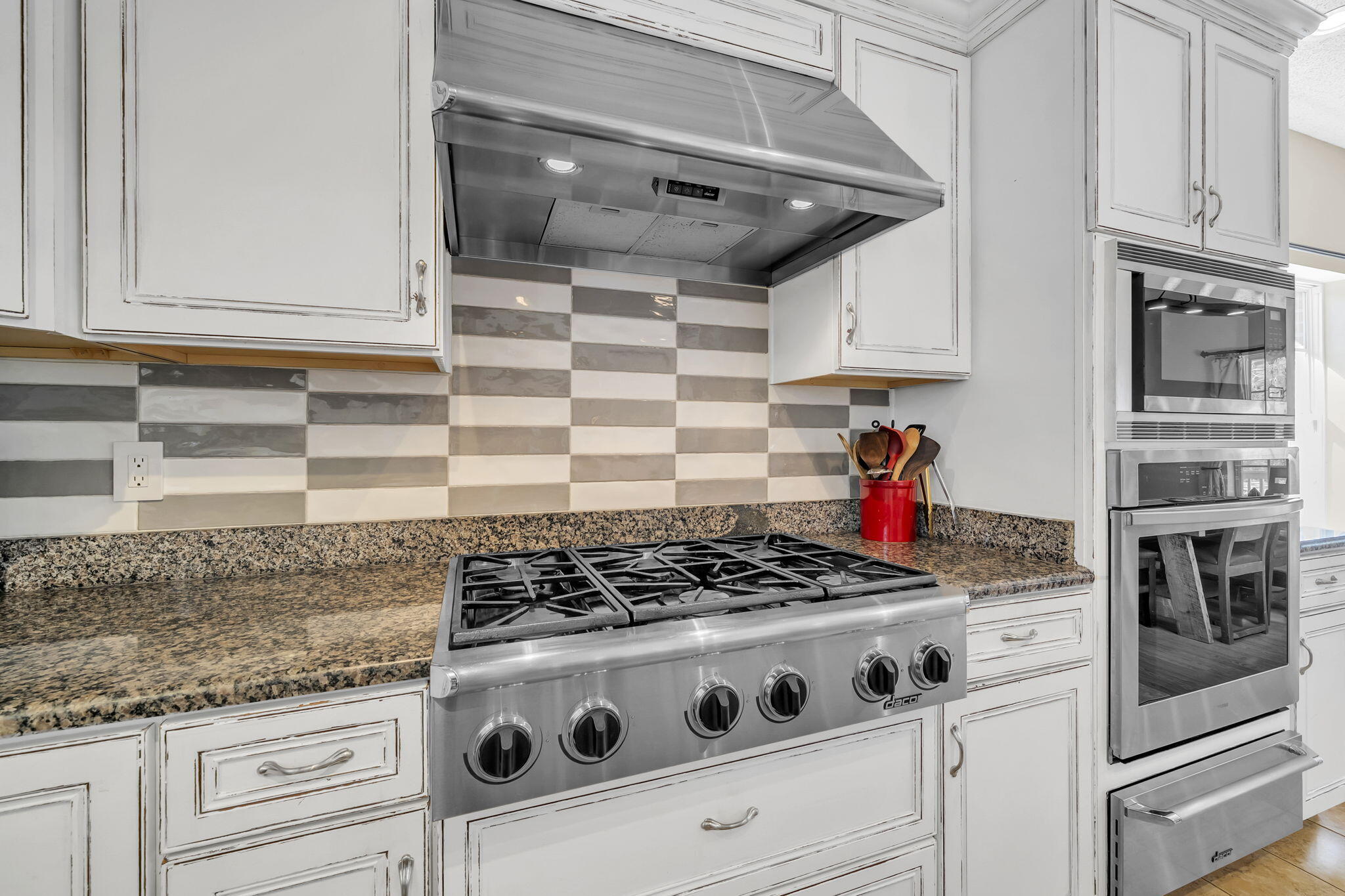 4398 Wilkerson Bluff Road Holt, FL 32564 - Photo 29 of 110 a kitchen with granite countertop white cabinets and stainless steel appliances