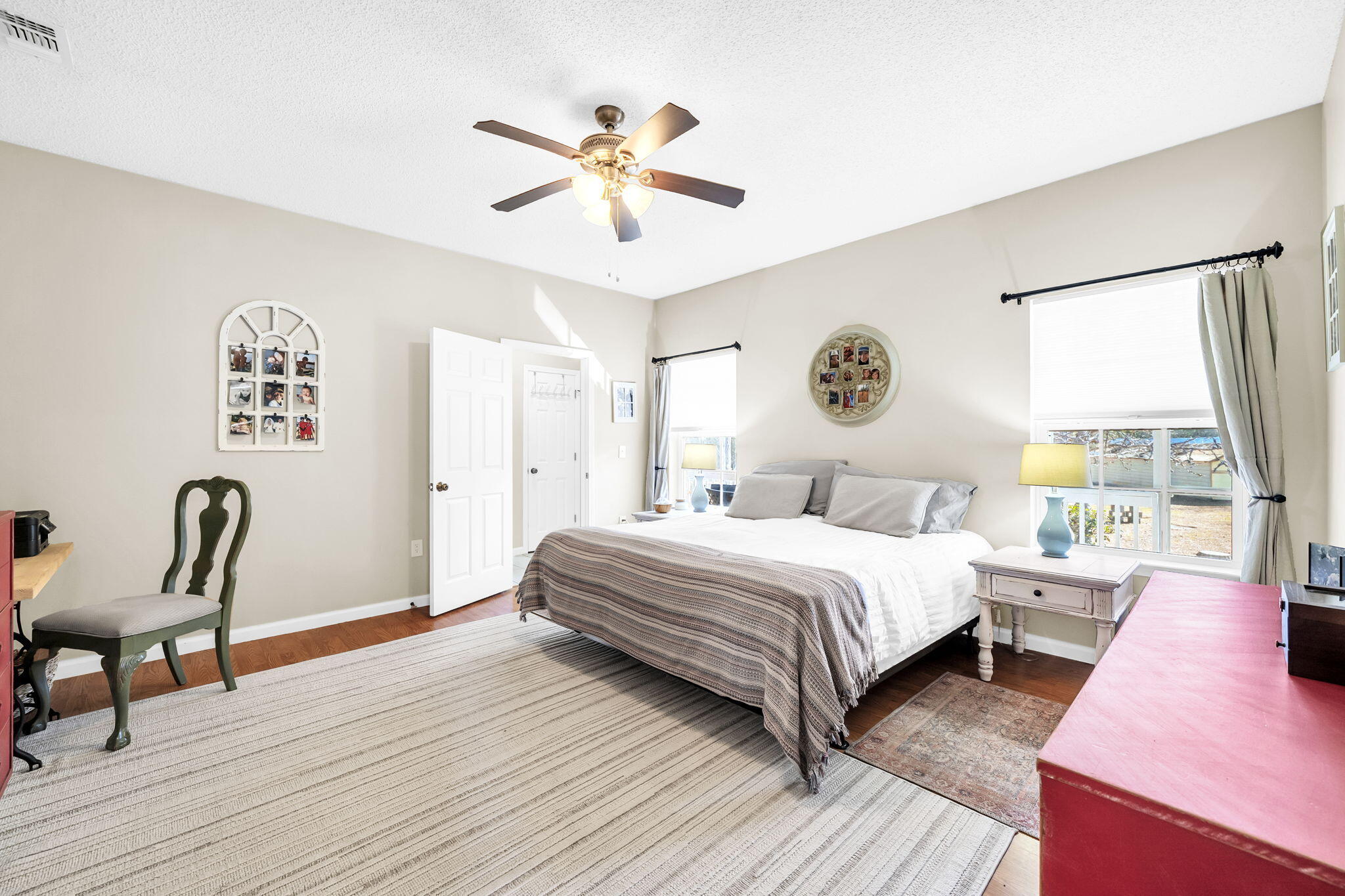 4398 Wilkerson Bluff Road Holt, FL 32564 - Photo 31 of 110 a bedroom with a bed a chandelier and a window