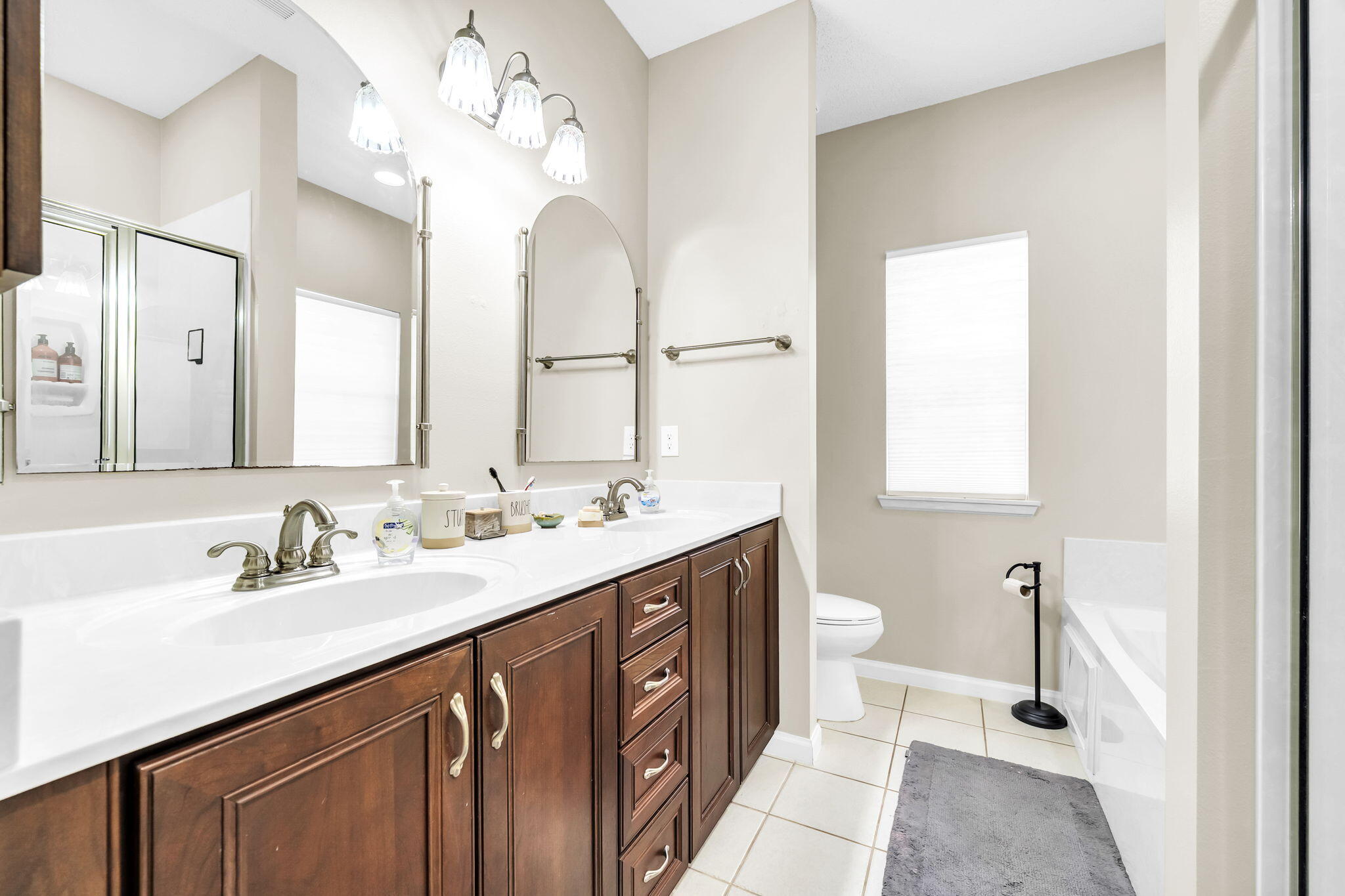 4398 Wilkerson Bluff Road Holt, FL 32564 - Photo 34 of 110 a bathroom with a double vanity sink and a mirror