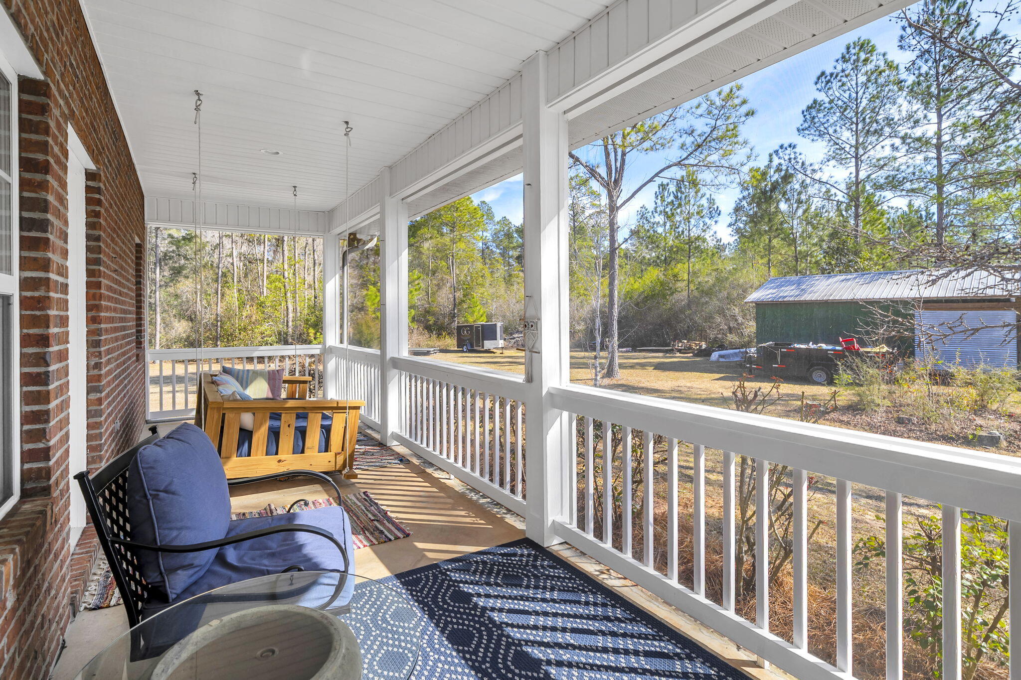 4398 Wilkerson Bluff Road Holt, FL 32564 - Photo 47 of 110 a view of a chair and tables in the balcony