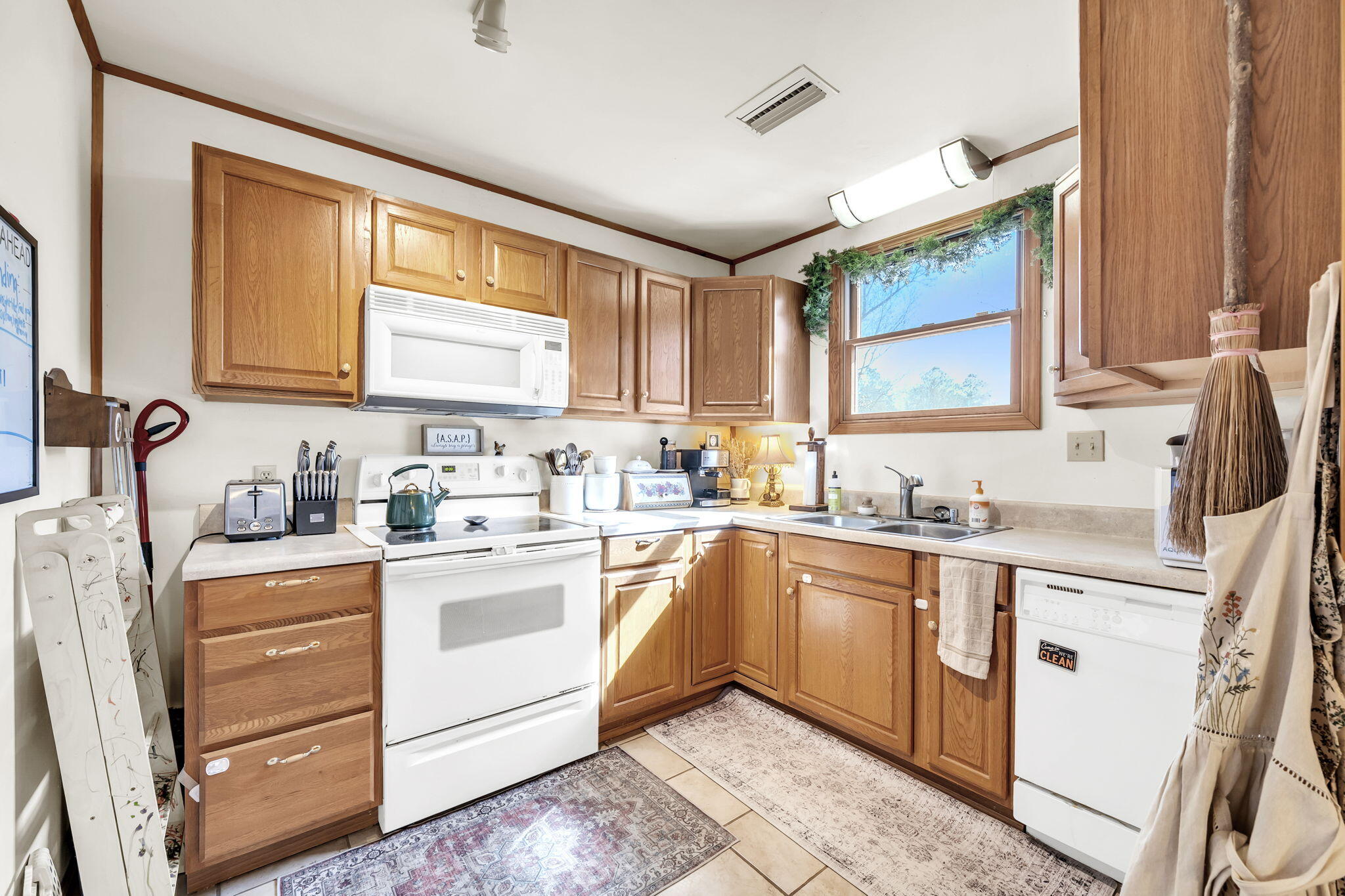 4398 Wilkerson Bluff Road Holt, FL 32564 - Photo 63 of 110 a kitchen with granite countertop white cabinets sink and stainless steel appliances