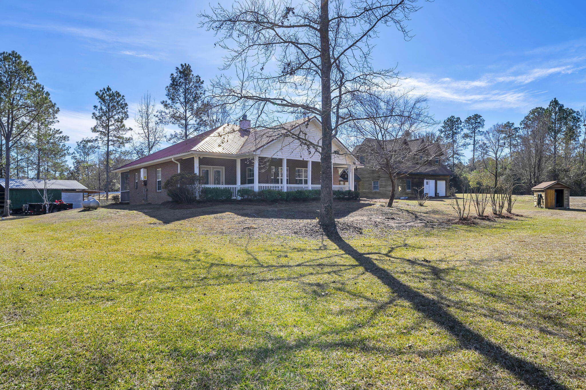 4398 Wilkerson Bluff Road Holt, FL 32564 - Photo 72 of 110 a view of swimming pool with large trees and a yard in front of it