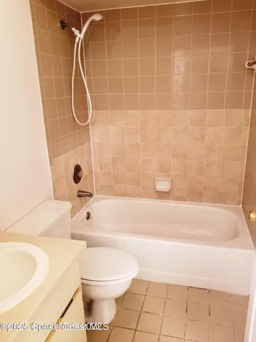 a bathroom with a toilet and a bath tub