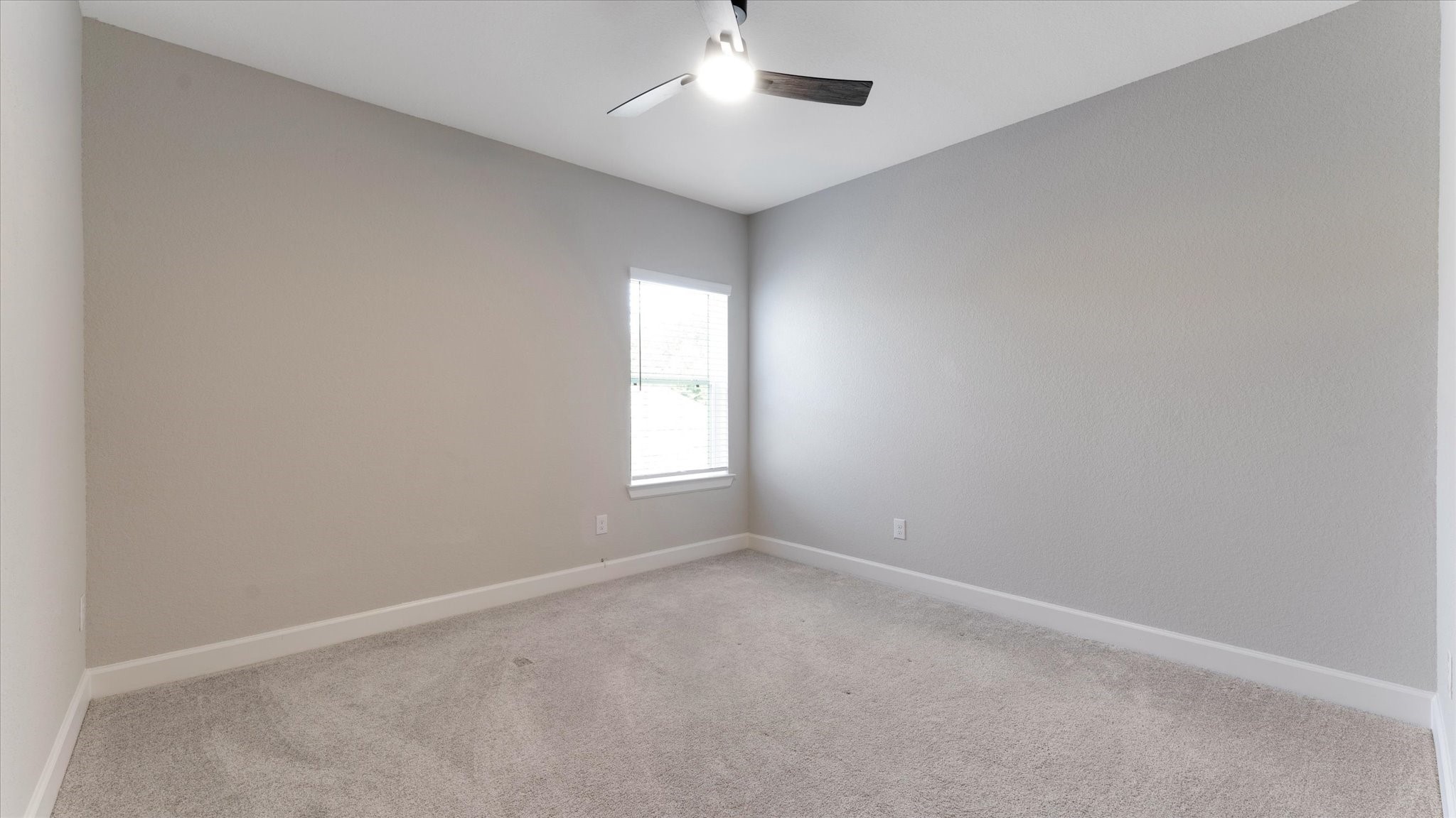 15607 Rising Wren Court Conroe, TX 77302 - Photo 32 of 40 an empty room with a window and ceiling fan