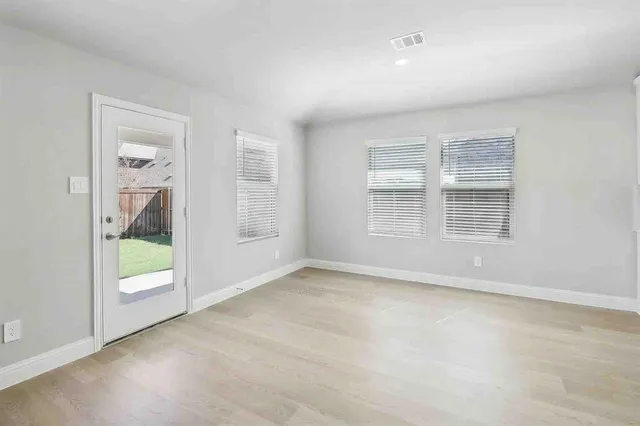 a kitchen with white cabinets and black appliances