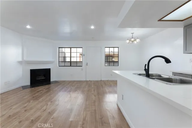 a kitchen with a sink and chandelier