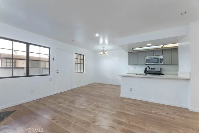 a view of kitchen with granite countertop cabinets and refrigerator