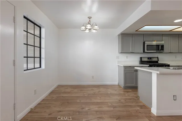 a kitchen with kitchen island granite countertop a sink cabinets and stainless steel appliances