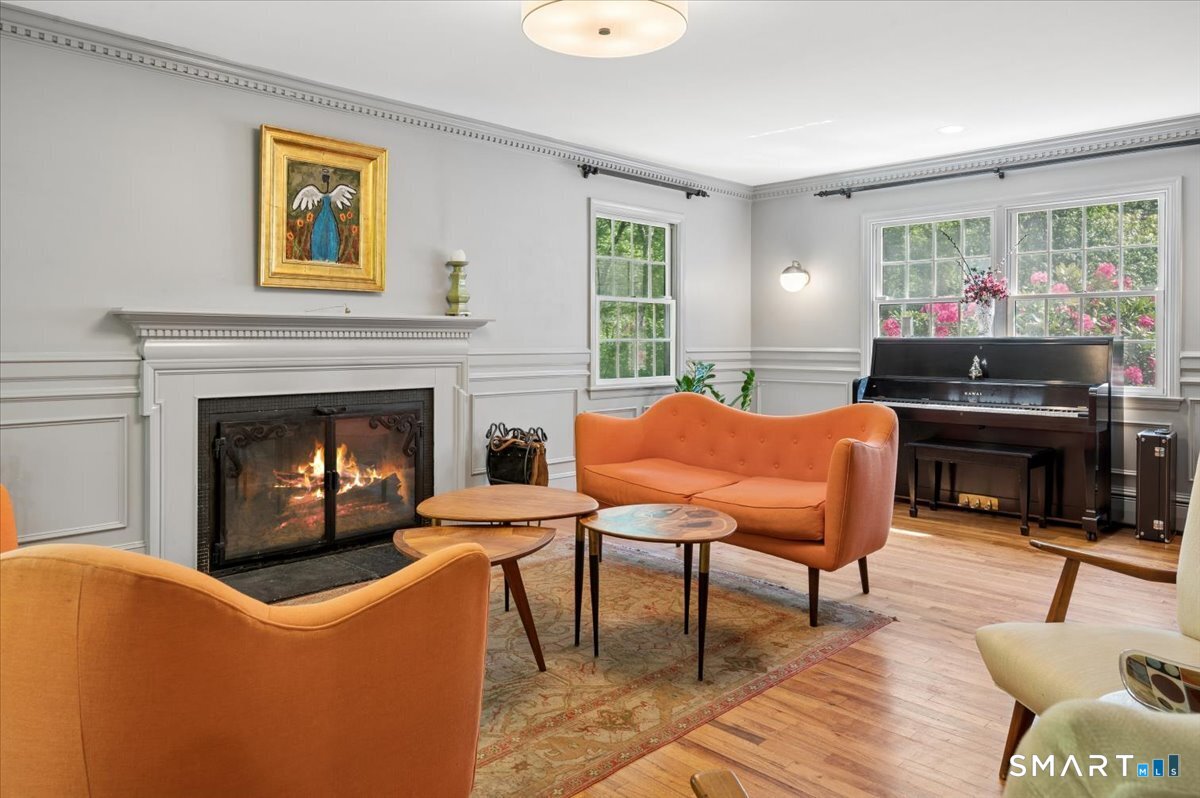 94 Vista Road Wilton, CT 06897 - Photo 5 of 38 a living room with furniture a piano and a fireplace