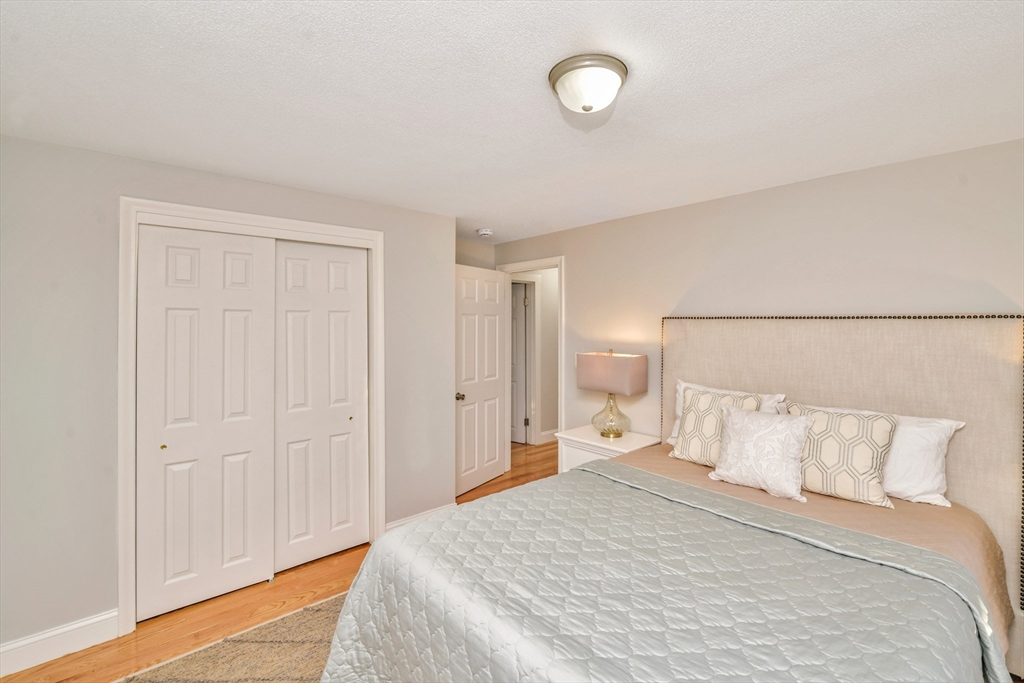 903 Main Street Bolton, MA 01740 - Photo 11 of 39 a bedroom with a bed and a lamp