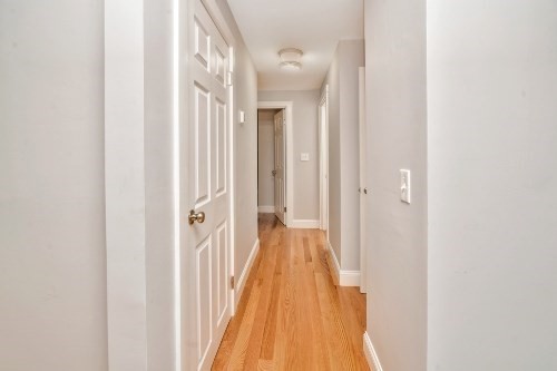 903 Main Street Bolton, MA 01740 - Photo 17 of 39 a view of a hallway with wooden floor