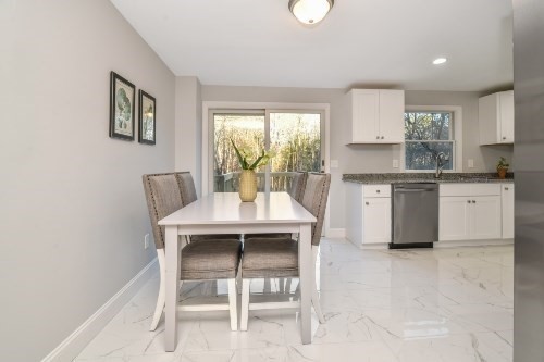 903 Main Street Bolton, MA 01740 - Photo 2 of 39 a kitchen with stainless steel appliances granite countertop a table chairs sink and cabinets