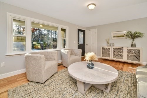 903 Main Street Bolton, MA 01740 - Photo 21 of 39 a living room with a couch and a table