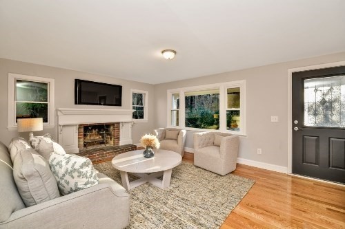 903 Main Street Bolton, MA 01740 - Photo 23 of 39 a living room with furniture a fireplace and a flat screen tv