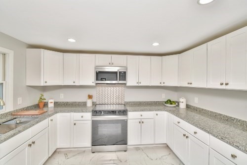 903 Main Street Bolton, MA 01740 - Photo 3 of 39 a kitchen with white cabinets appliances and sink