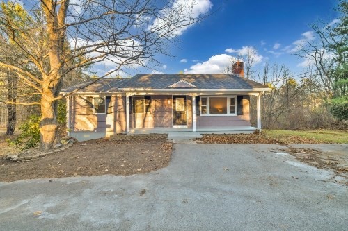 903 Main Street Bolton, MA 01740 - Photo 32 of 39 a front view of a house with a yard and garage