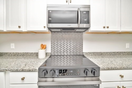 903 Main Street Bolton, MA 01740 - Photo 7 of 39 a kitchen with granite countertop a stove and a sink