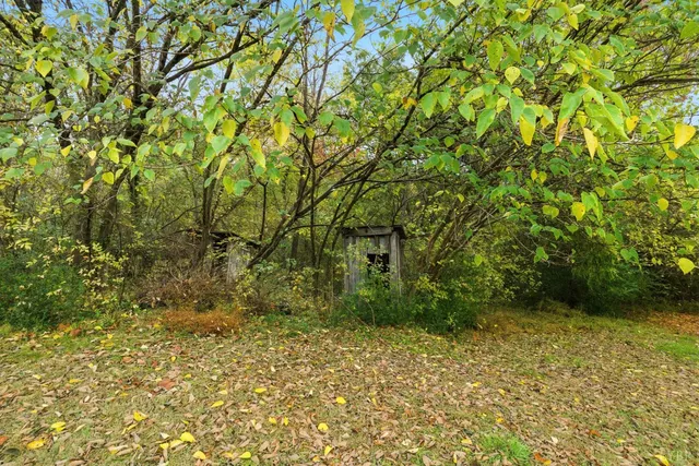 a view of a house with a wooden fence