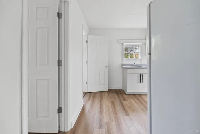a view of kitchen with wooden floor and window