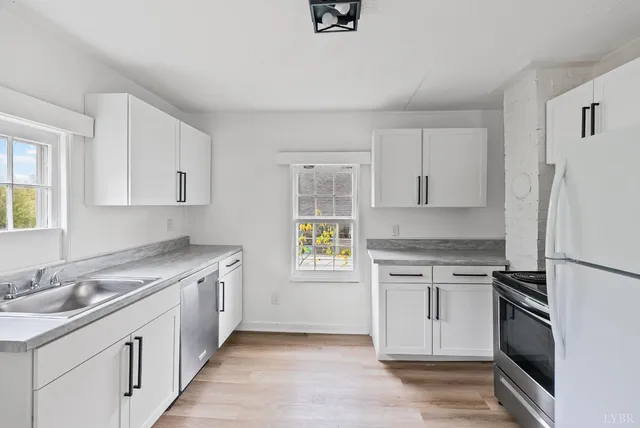 a kitchen with a sink stove and refrigerator