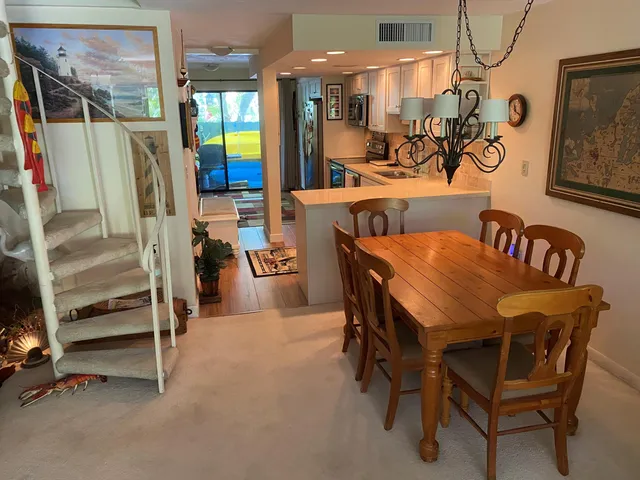 a dining room with furniture and a floor to ceiling window