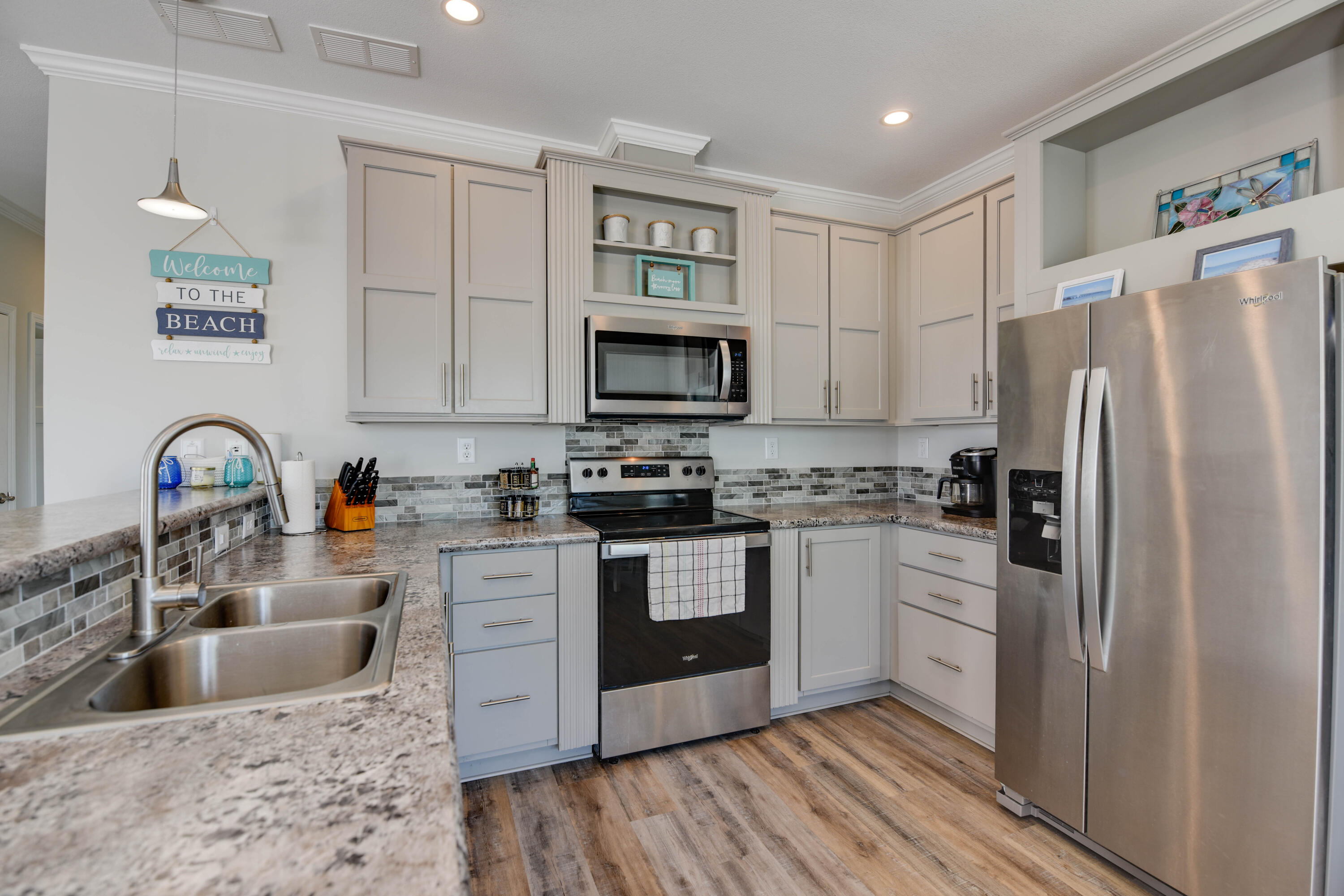 31343 Ave I Big Pine Key, FL 33043 - Photo 5 of 29 a kitchen with stainless steel appliances granite countertop a refrigerator stove and sink