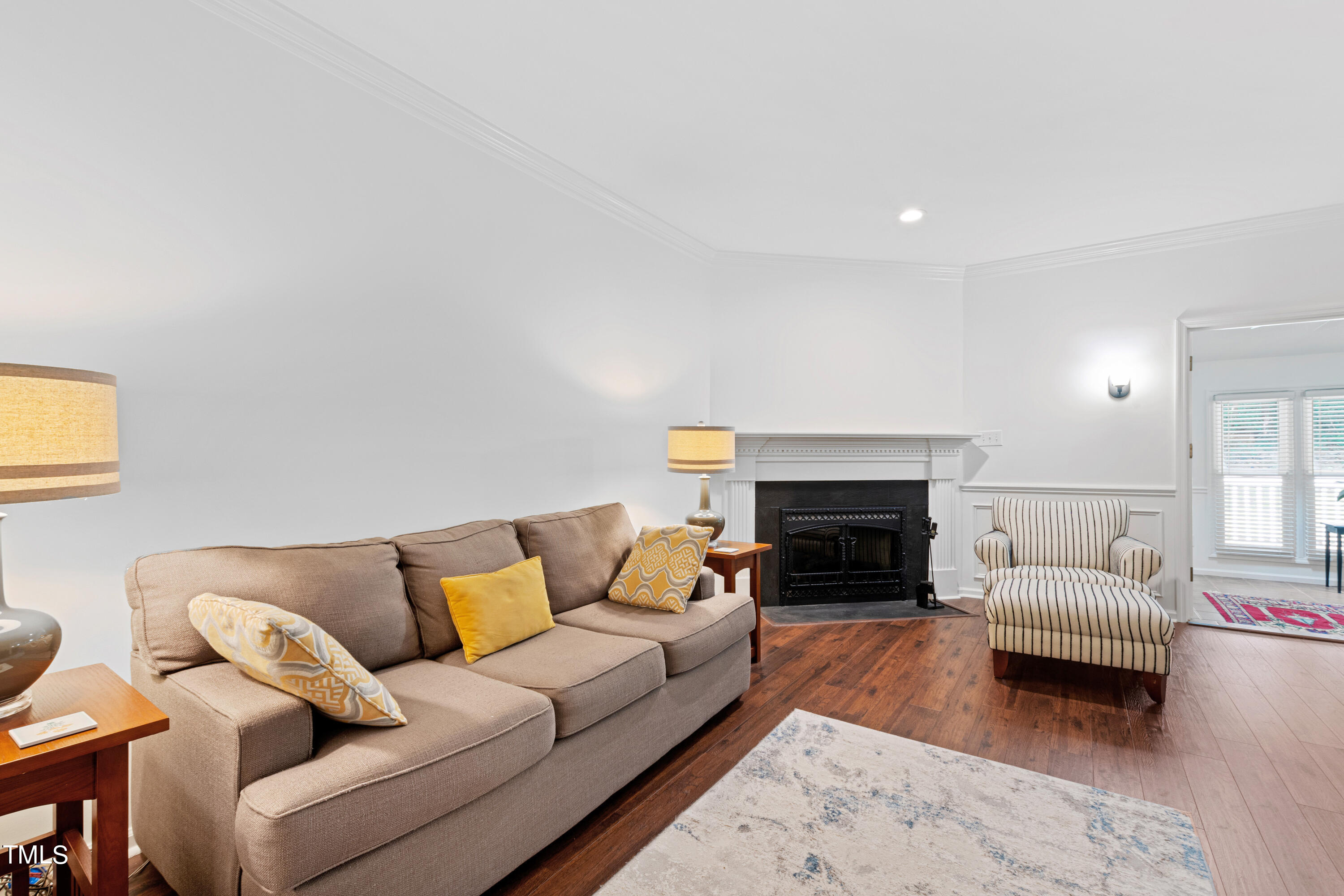 3834 Carnegie Lane Raleigh, NC 27612 - Photo 14 of 38 a living room with furniture a fireplace and a table