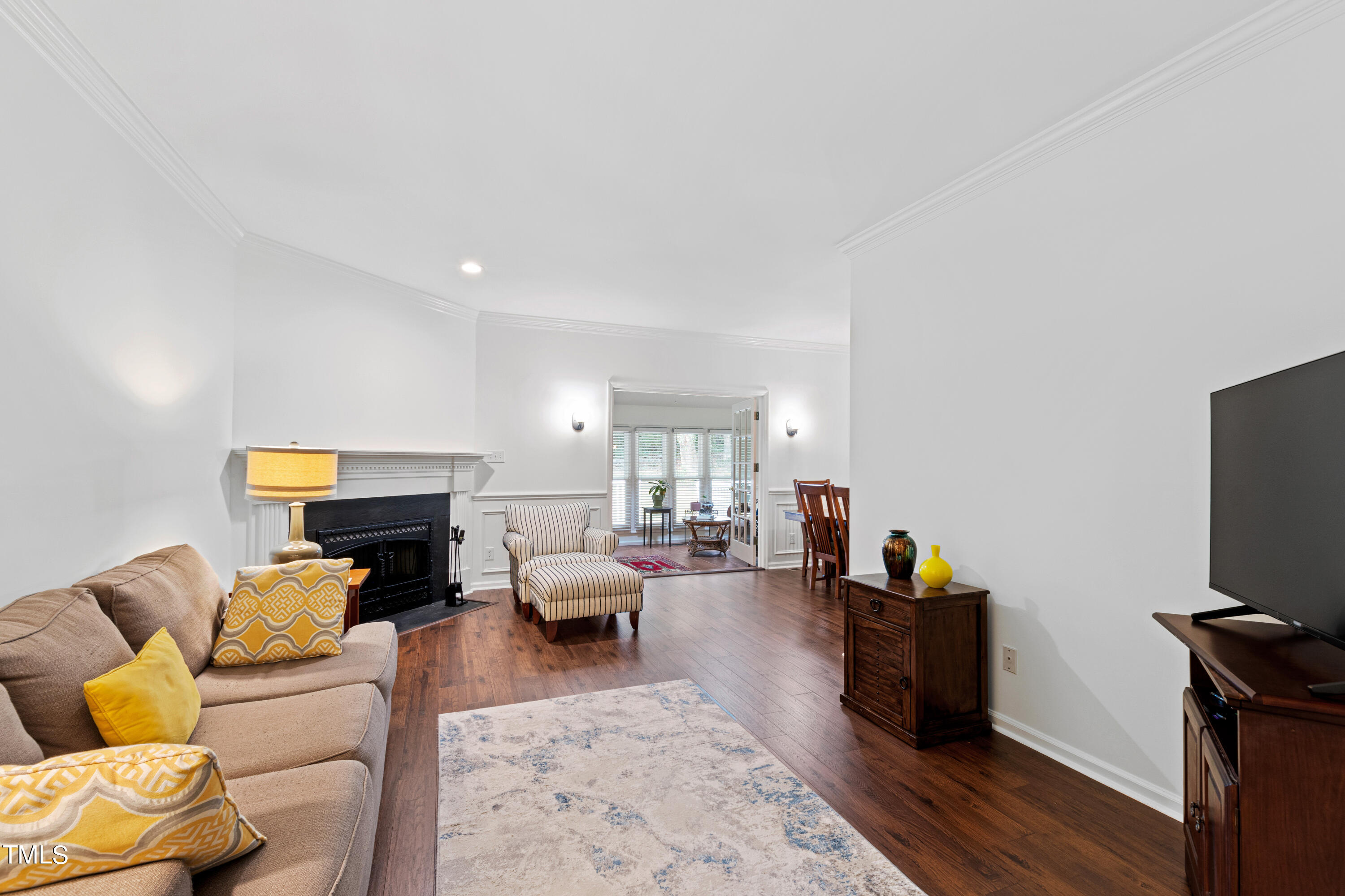 3834 Carnegie Lane Raleigh, NC 27612 - Photo 15 of 38 a living room with furniture and a flat screen tv