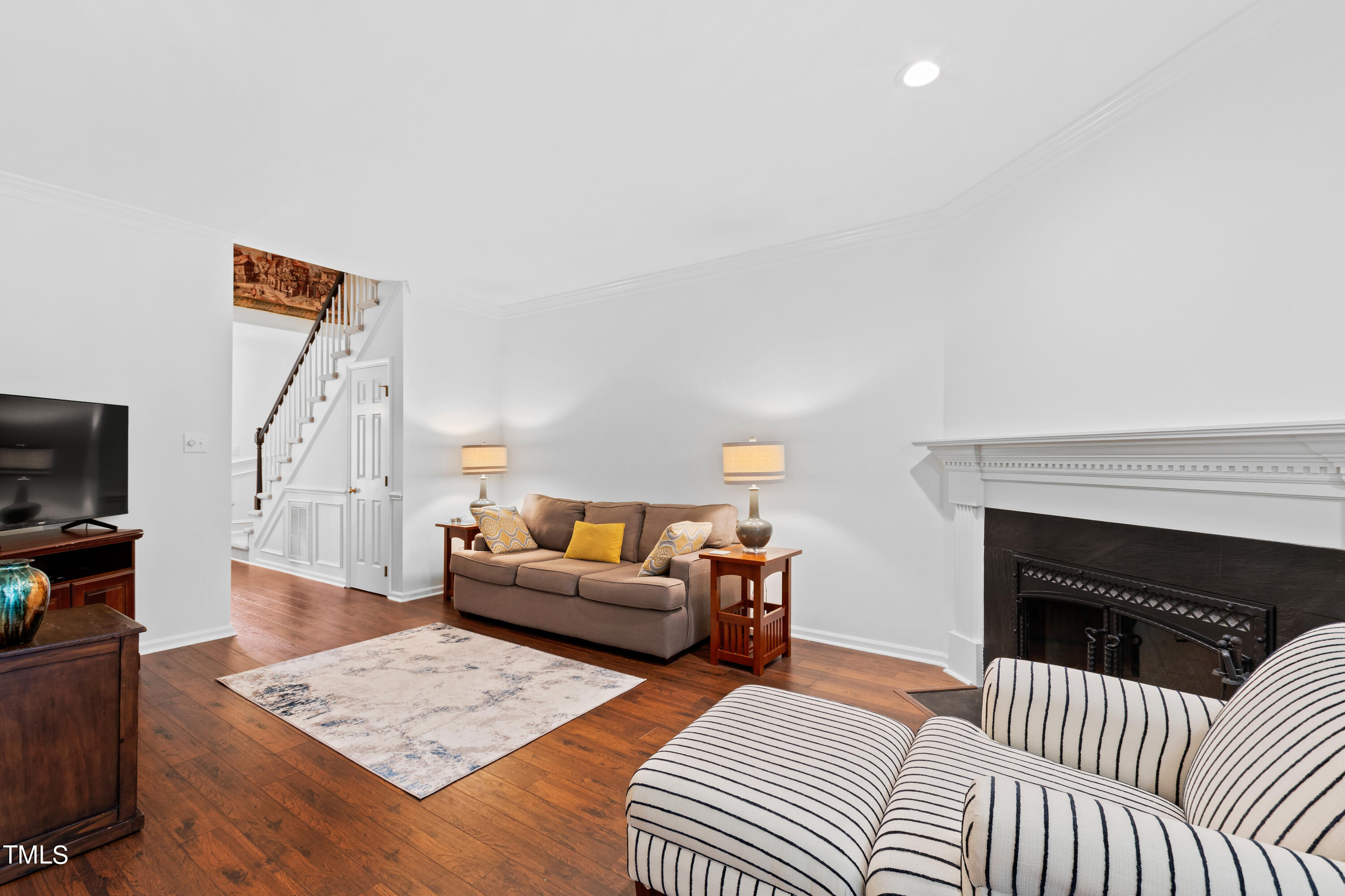 3834 Carnegie Lane Raleigh, NC 27612 - Photo 17 of 38 a living room with furniture and a fireplace