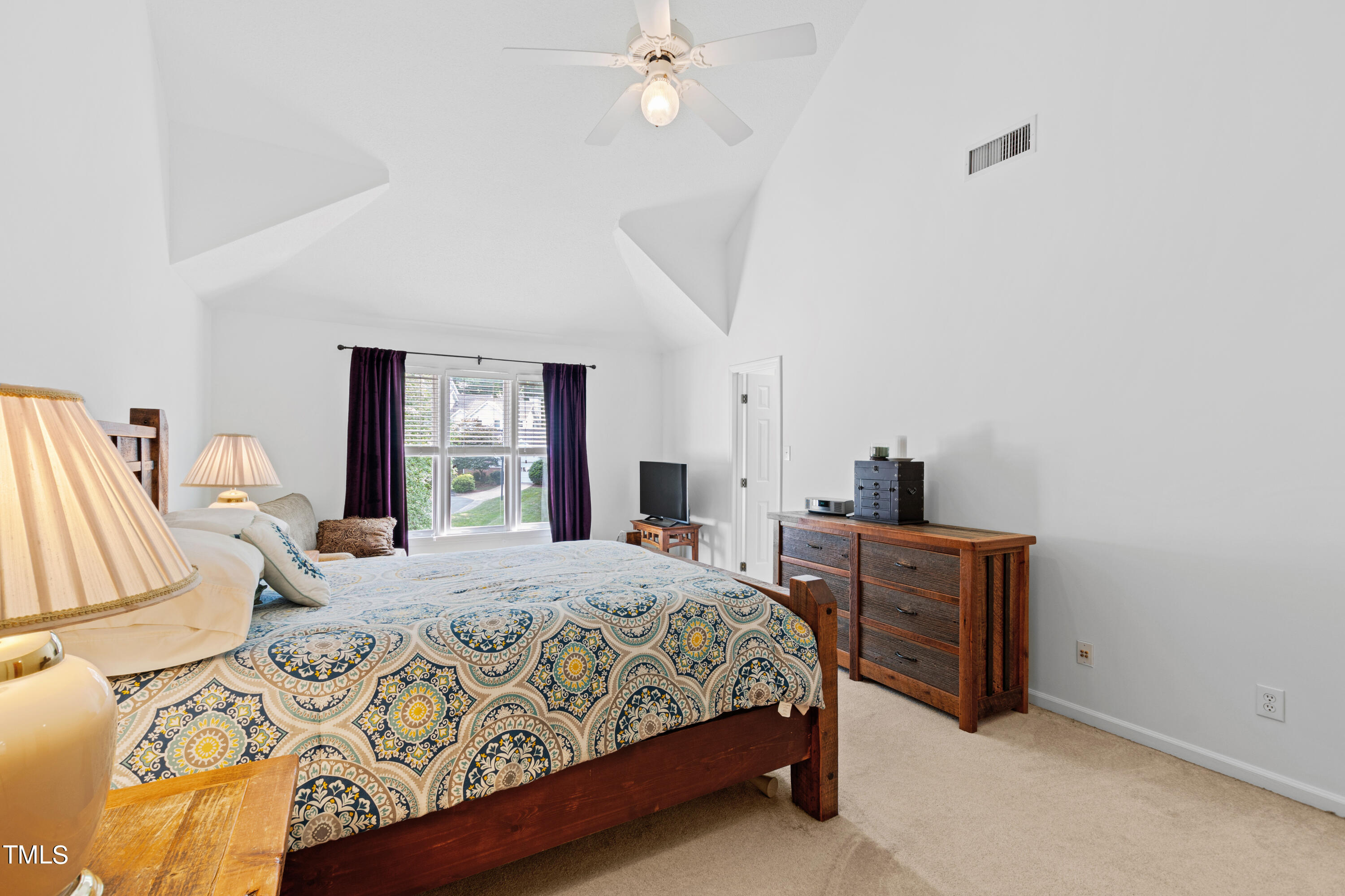 3834 Carnegie Lane Raleigh, NC 27612 - Photo 24 of 38 a bedroom with a large bed and a window