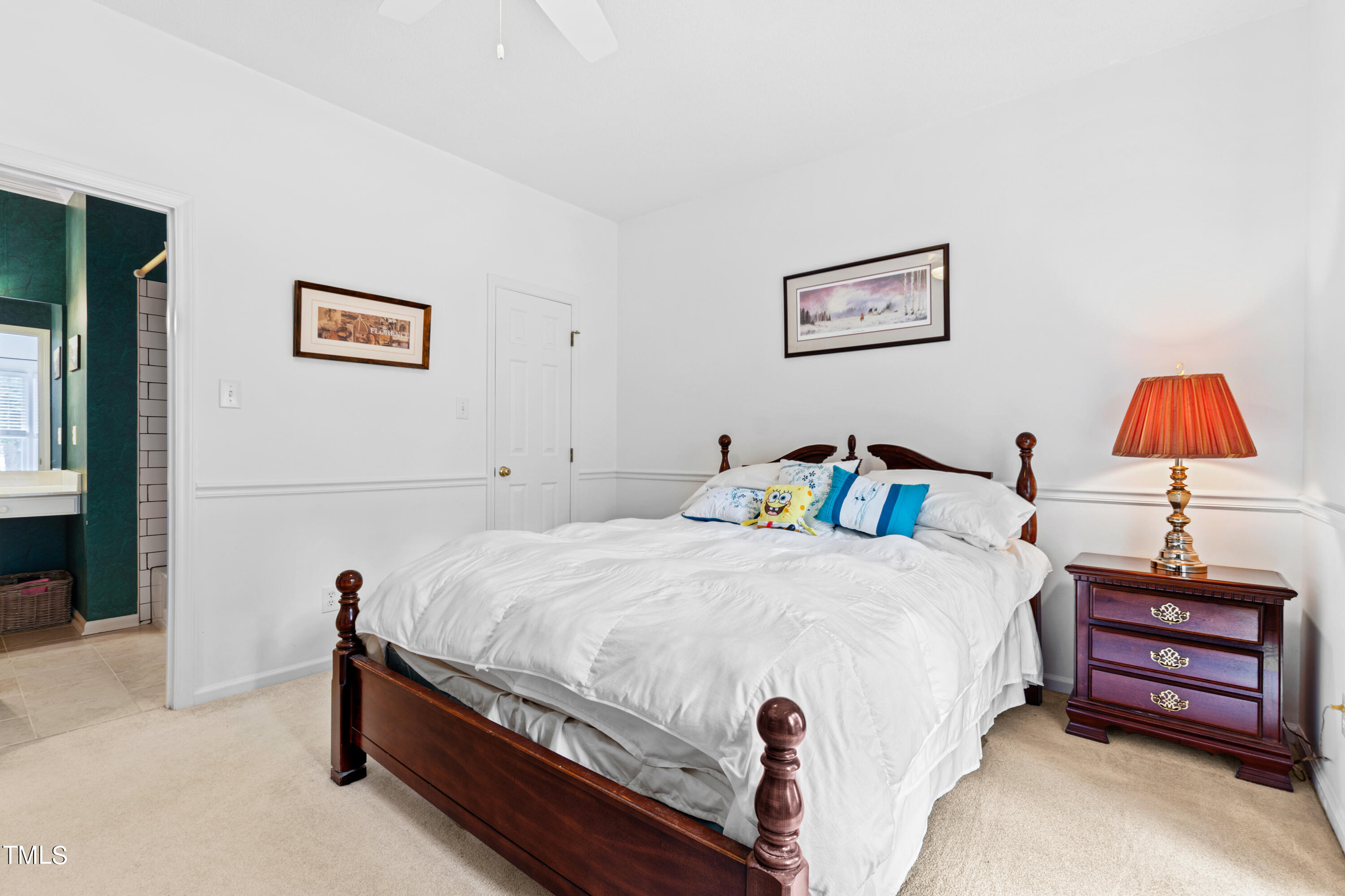 3834 Carnegie Lane Raleigh, NC 27612 - Photo 26 of 38 a bedroom with a bed and a lamp on table