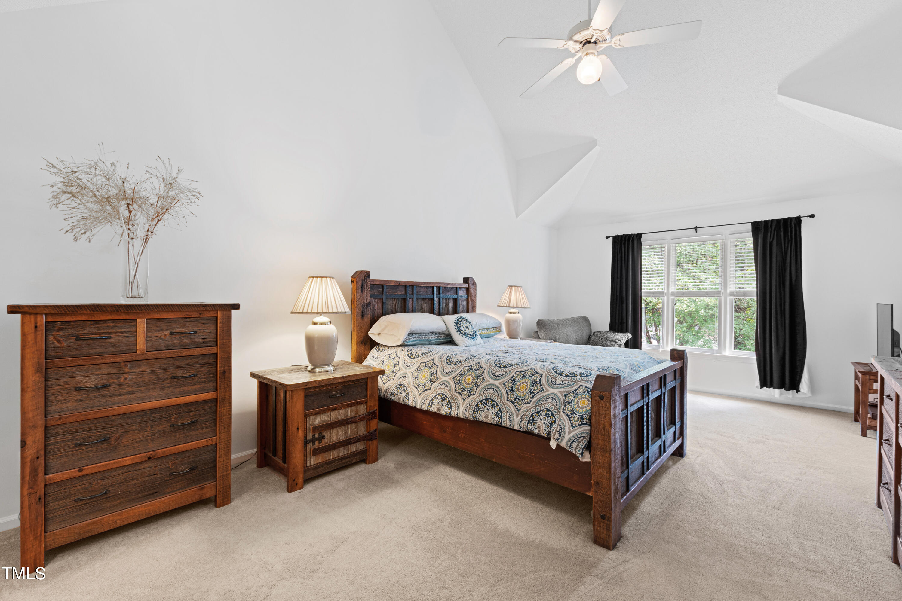 3834 Carnegie Lane Raleigh, NC 27612 - Photo 28 of 38 a bedroom with a bed and a chandelier