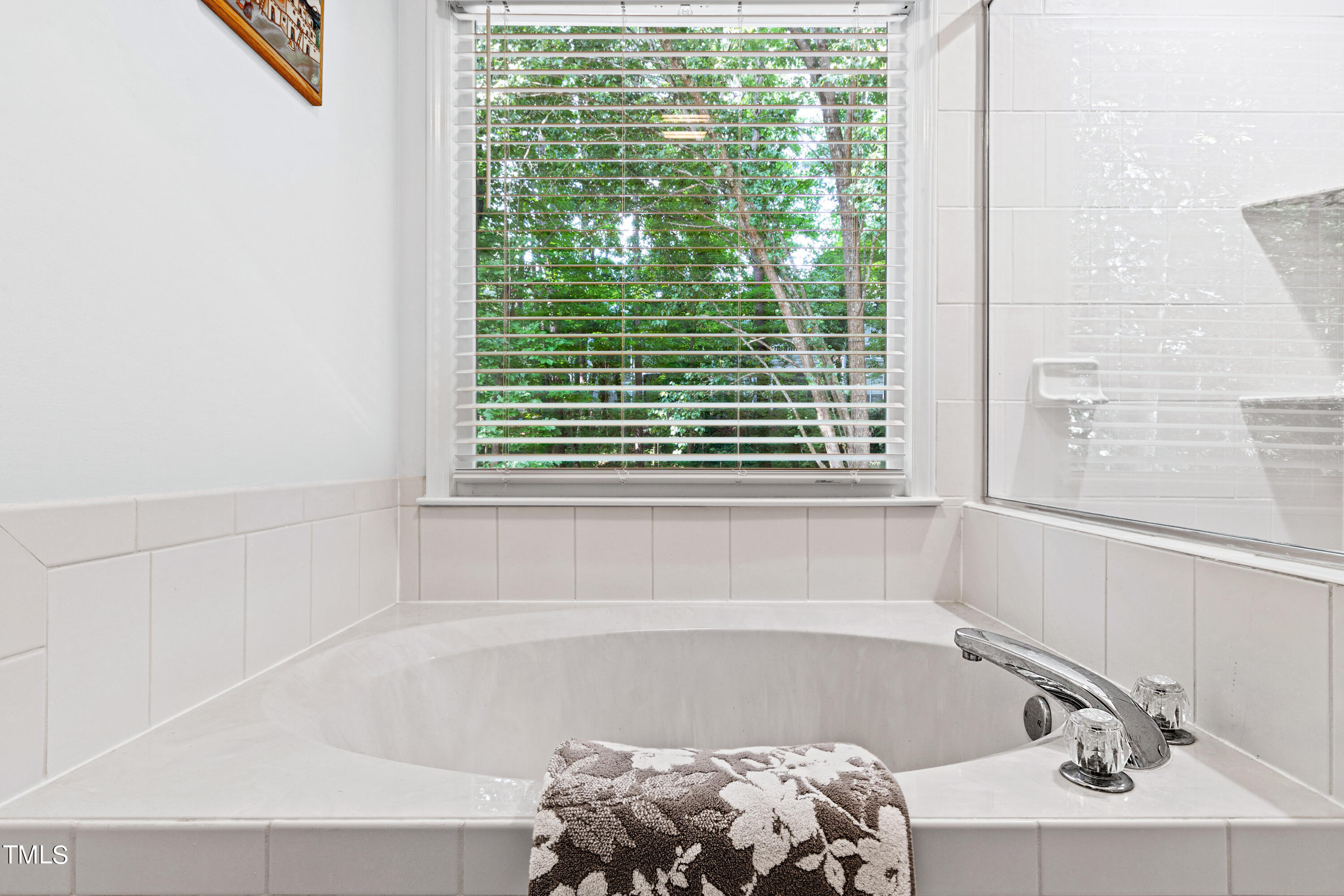 3834 Carnegie Lane Raleigh, NC 27612 - Photo 34 of 38 a bath tub sitting in a bathroom next to a window