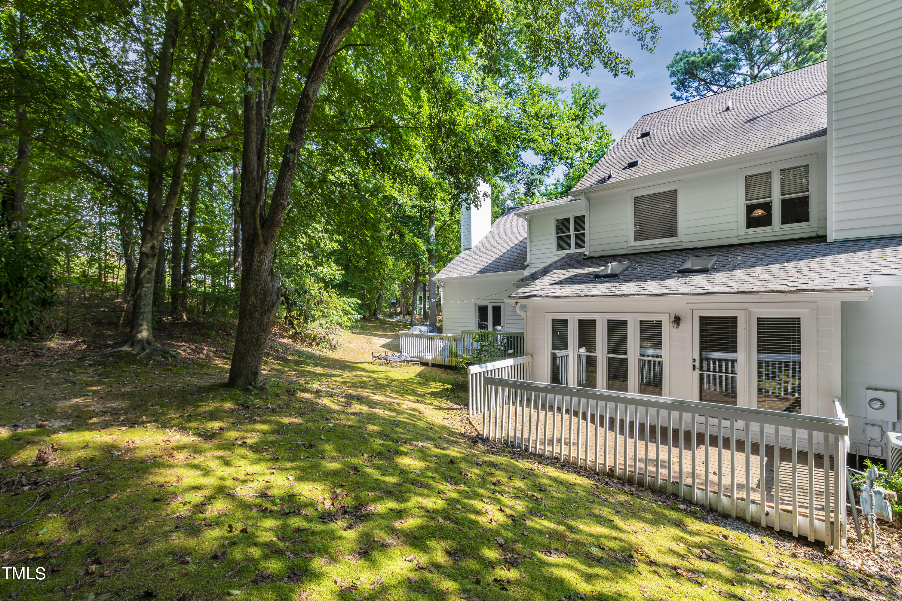 3834 Carnegie Lane Raleigh, NC 27612 - Photo 36 of 38 a view of a house with a wooden deck and a yard
