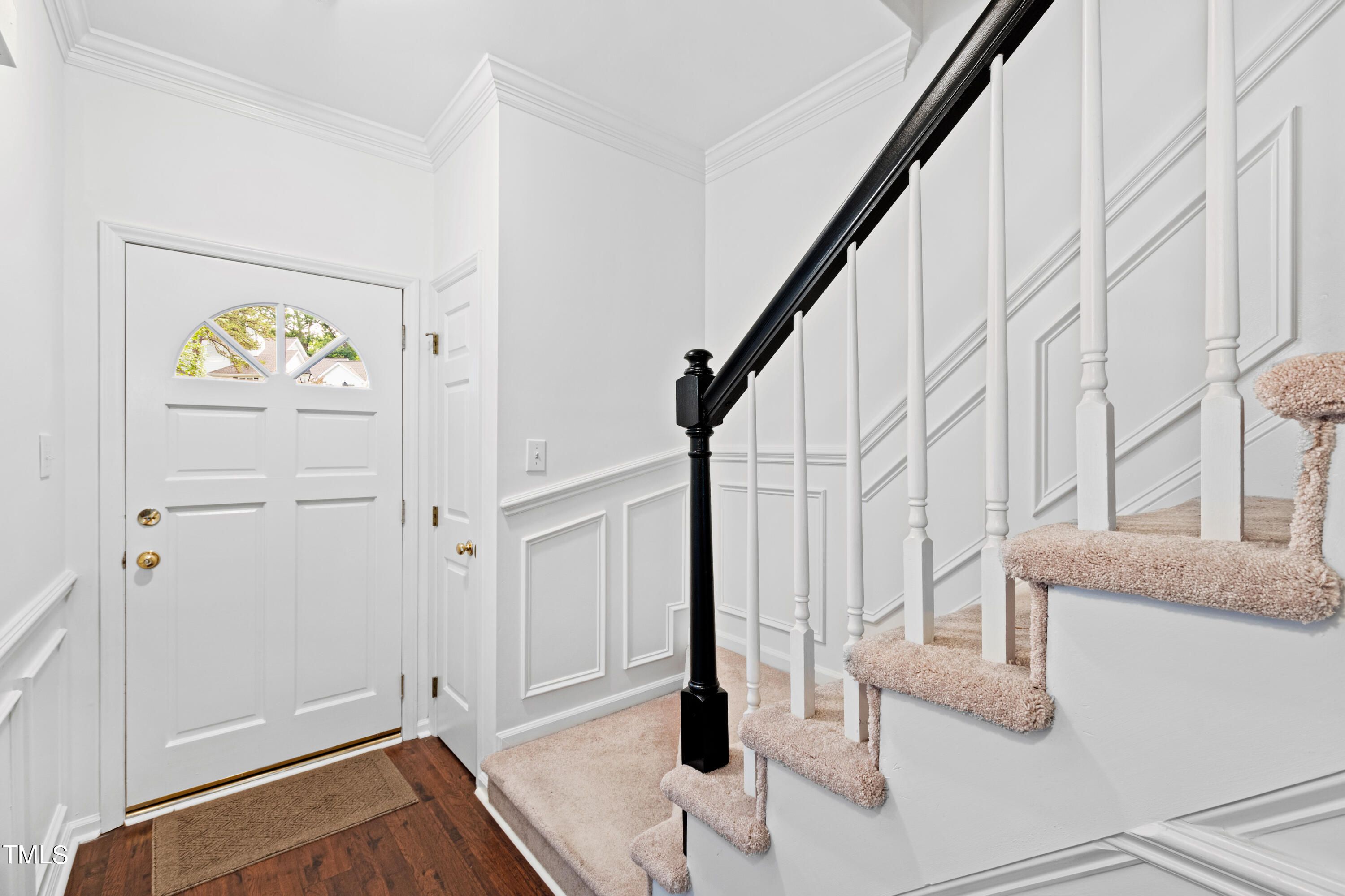 3834 Carnegie Lane Raleigh, NC 27612 - Photo 5 of 38 a view of entryway with stairs and wooden floor